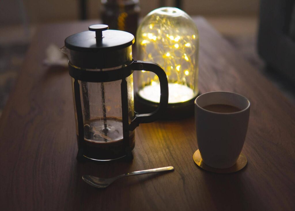 french press and a cup of coffee