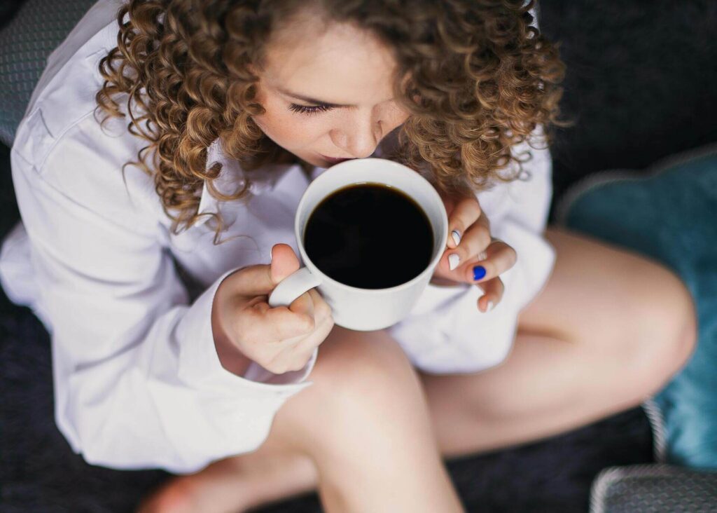 woman drinking black coffee