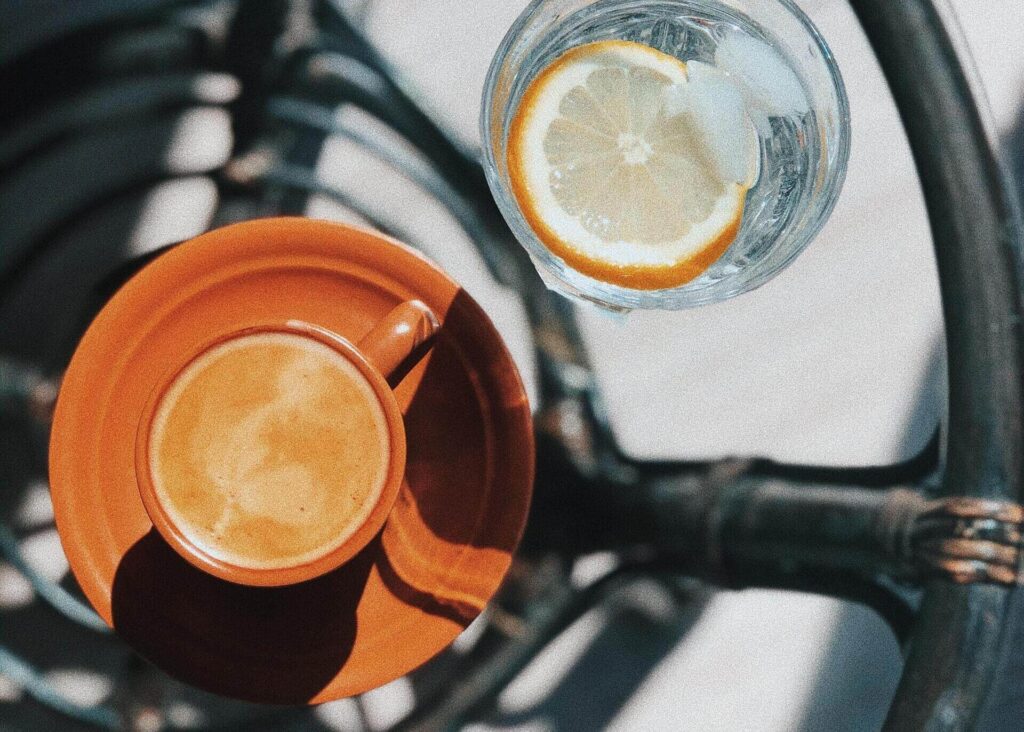 espresso cup and water with lemon