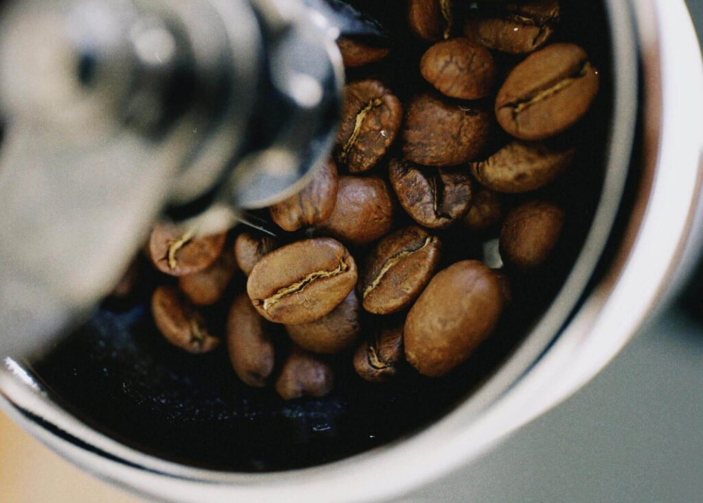 medium roasted coffee beans in a grinder