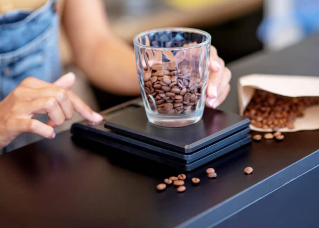 woman weighing coffee beans