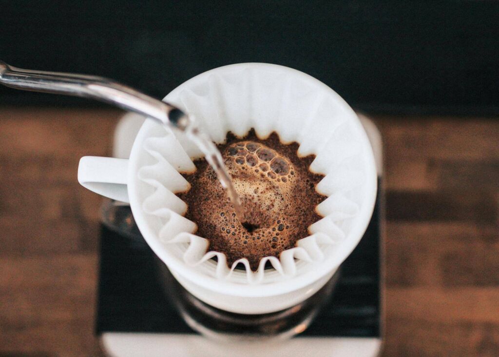 pouring water over coffee