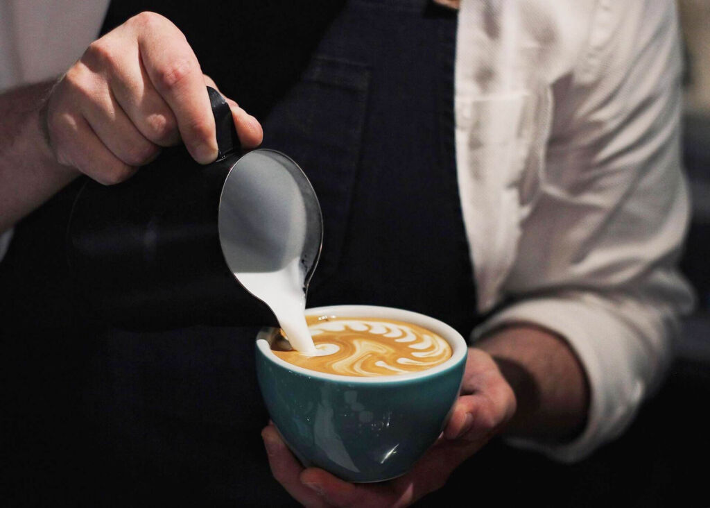 barista pouring latte art