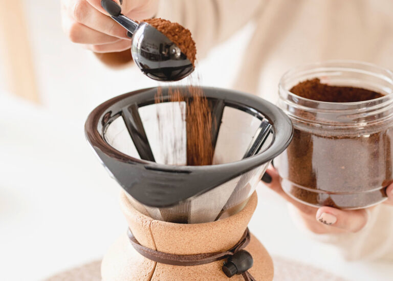 adding ground coffee into bodum pour over