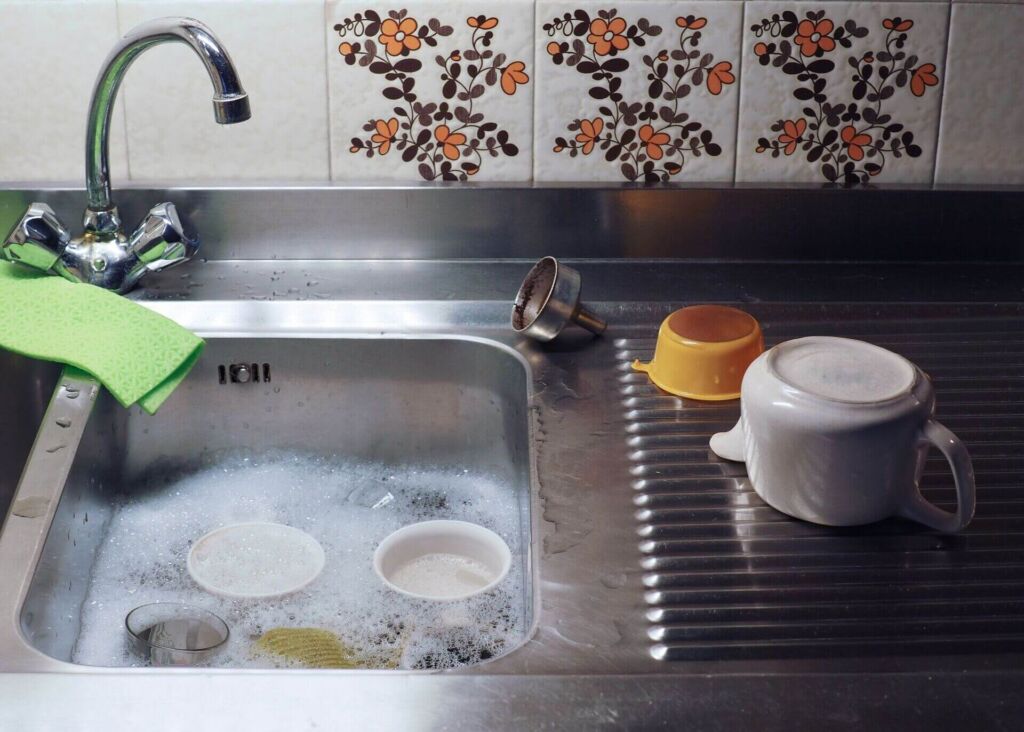 dishes floating in a sink