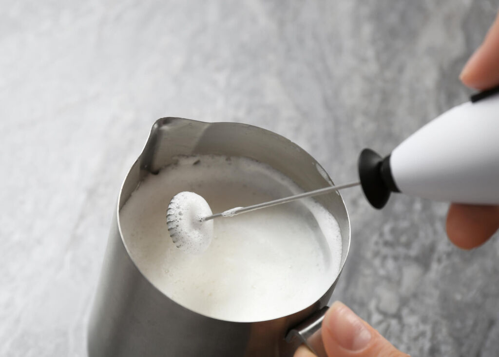 frothing milk with a handheld frother
