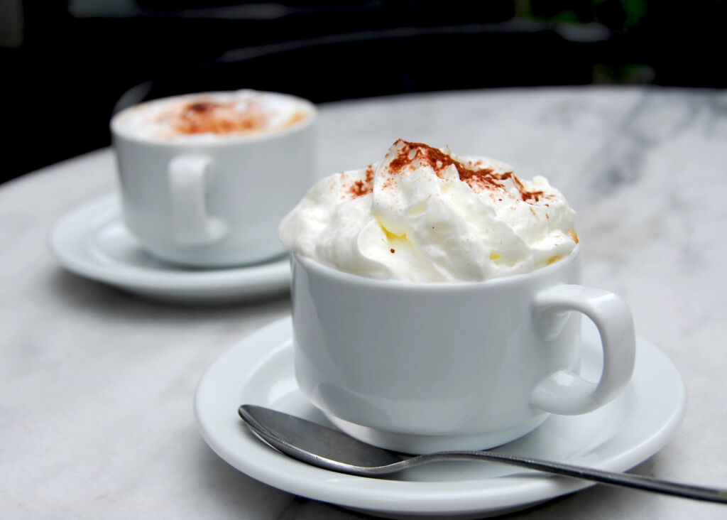 cappuccino with whipped cream on a table