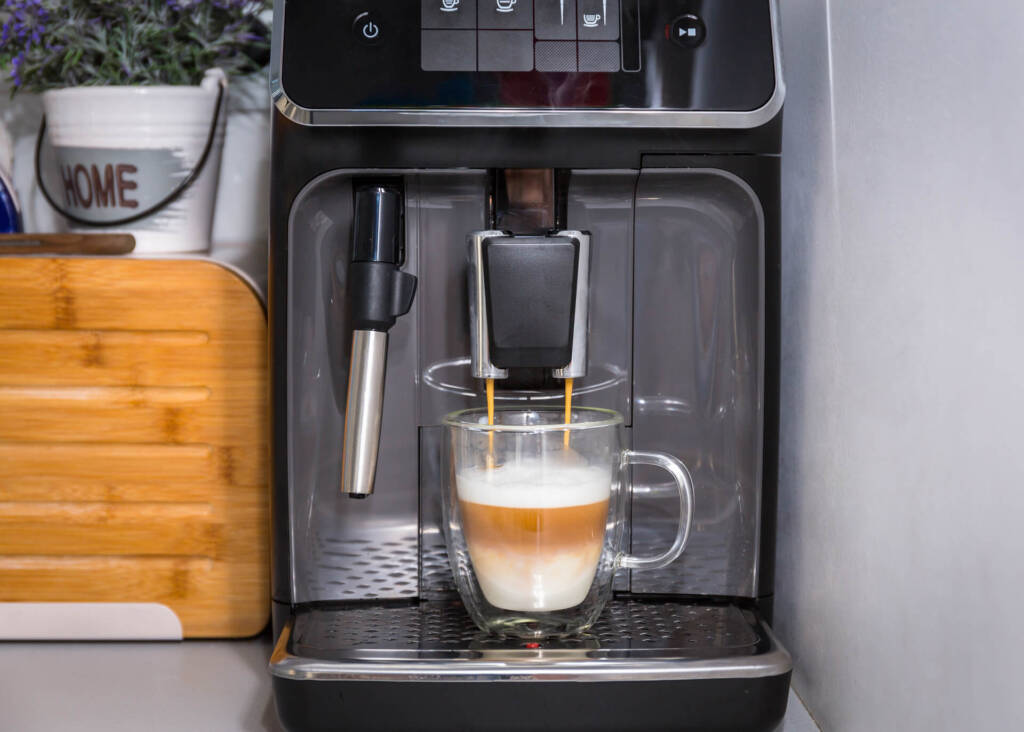 super automatic home espresso machine brewing latte