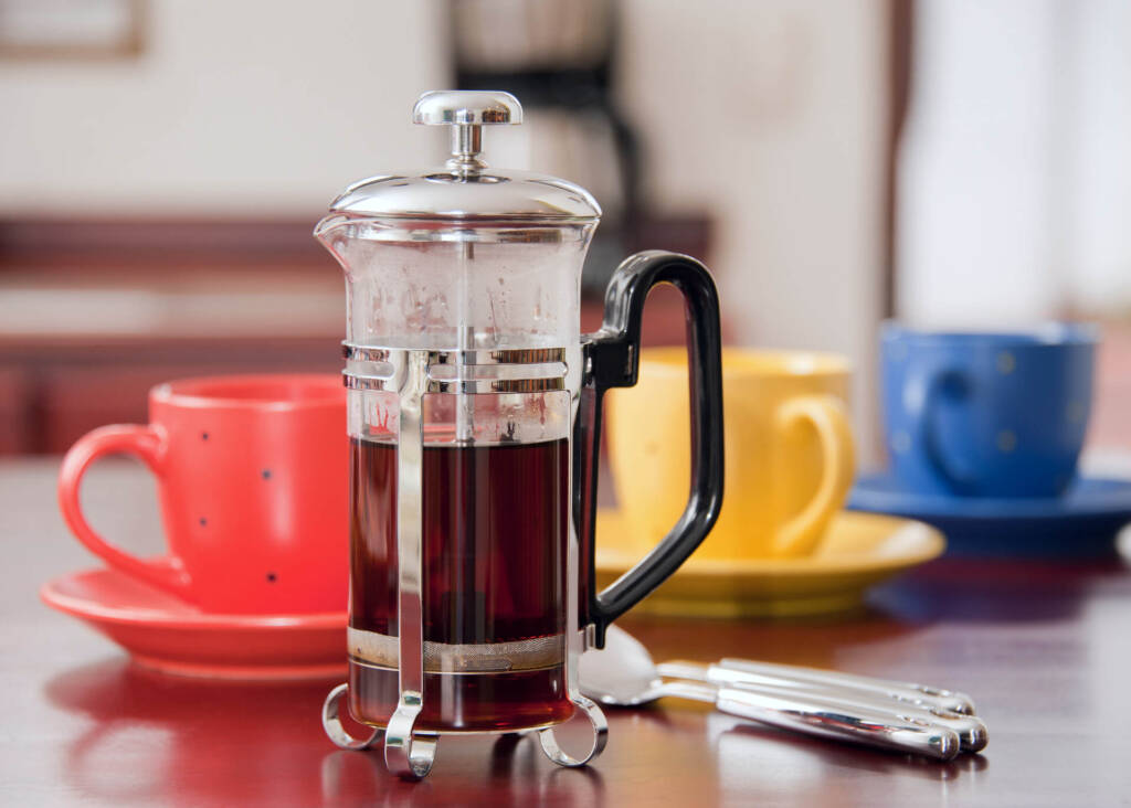 french press with coffee and cups