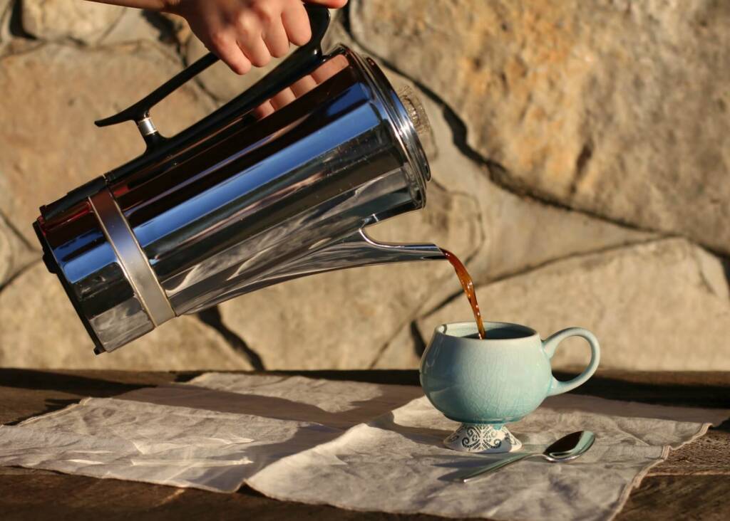 pouring coffee from a large percolator